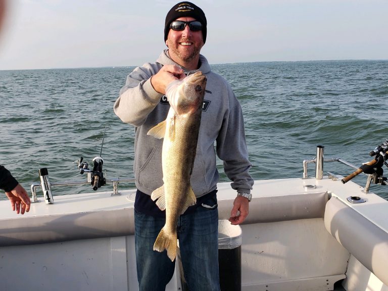 man on boat with walleye